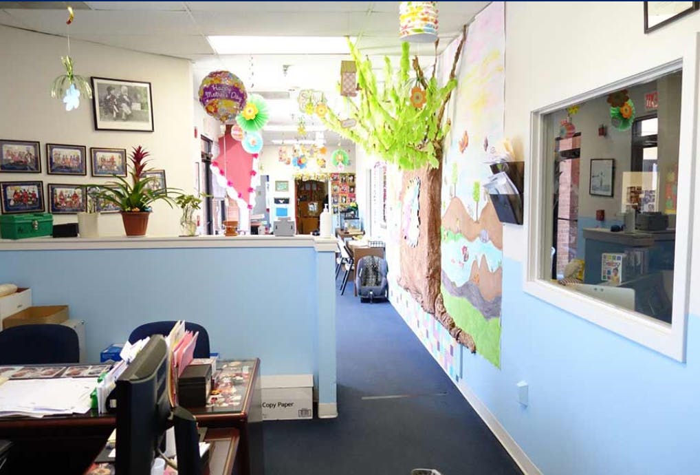 Office interior with a blue half-wall and a decorated hallway