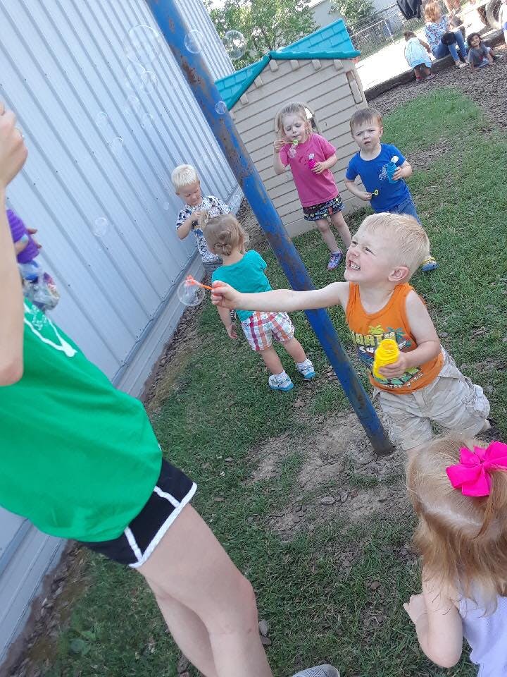 Children playing with bubbles outdoors