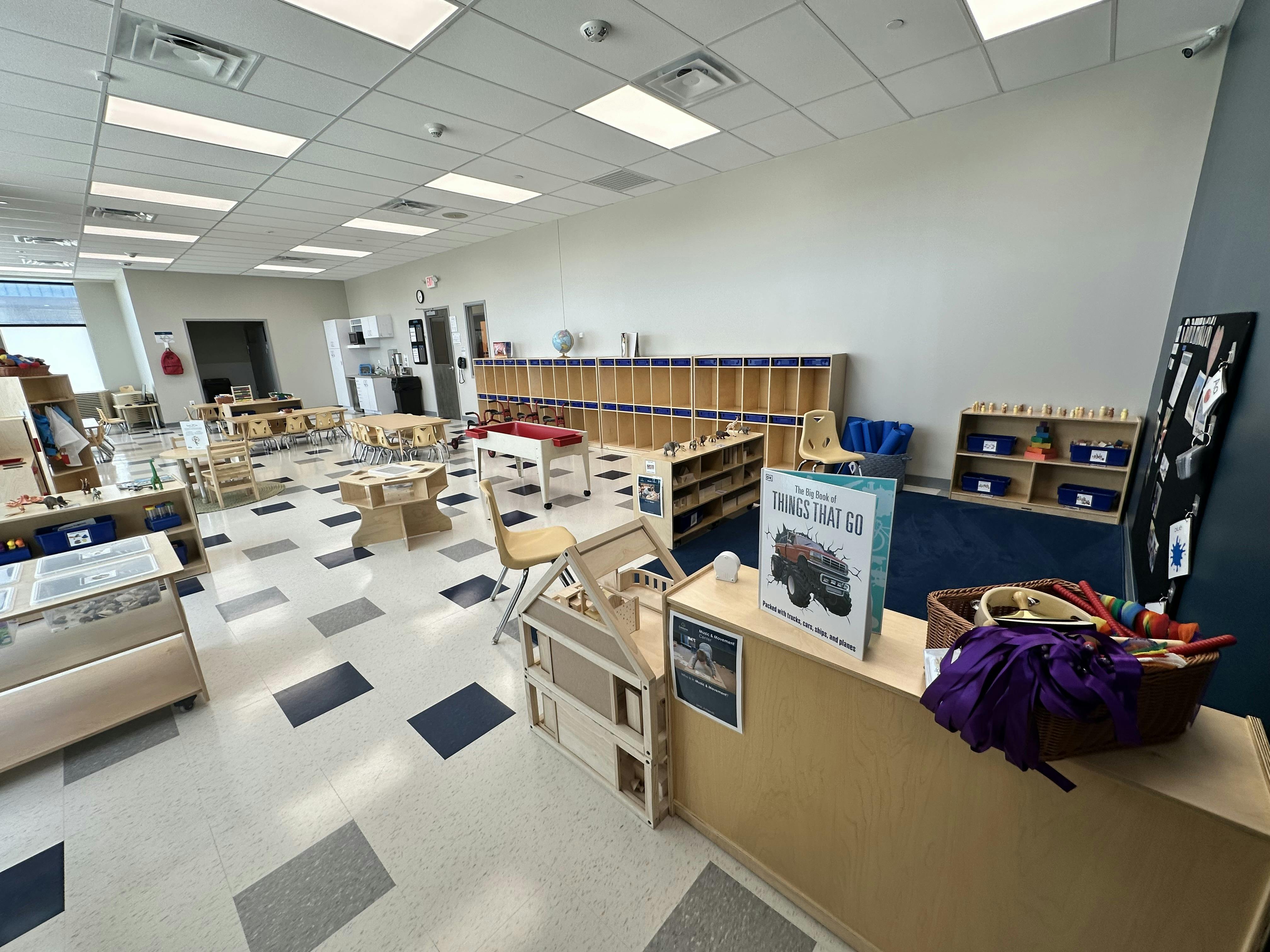 Classroom with tables, chairs, and cubbies