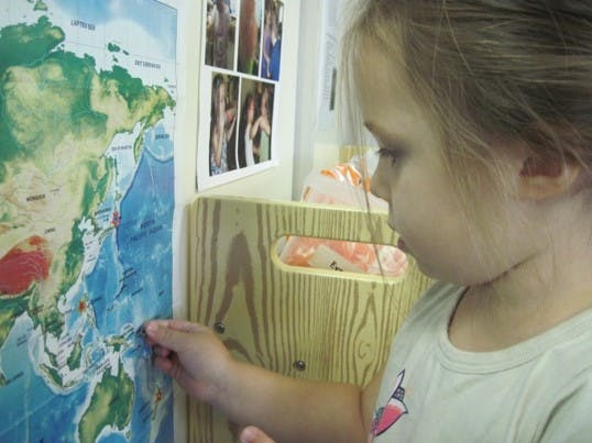 Child pointing at a map
