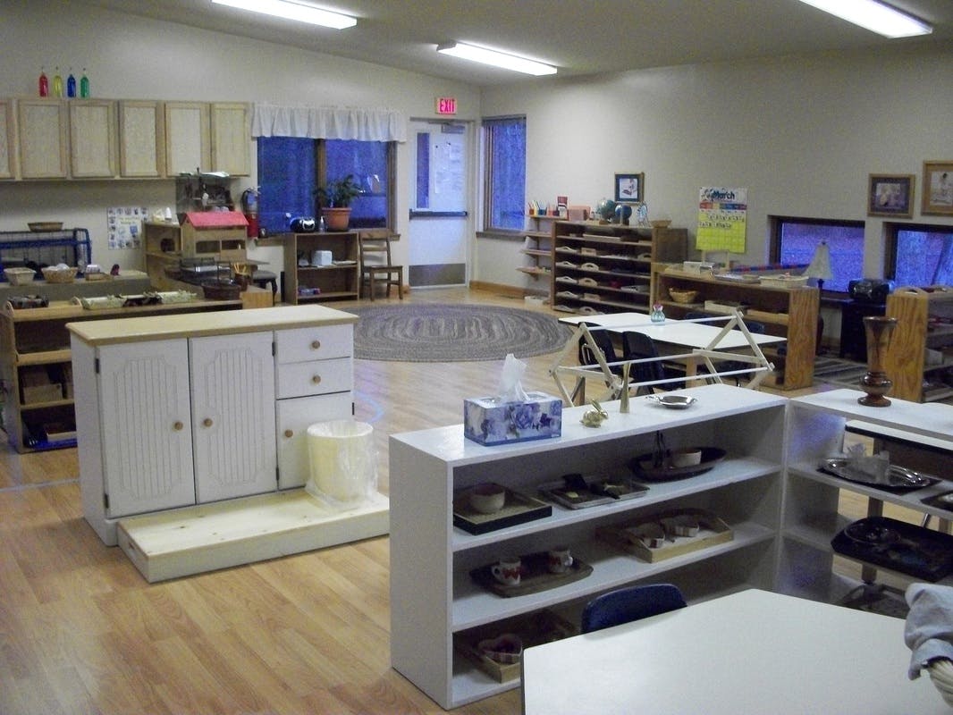 Classroom with various learning stations and shelves