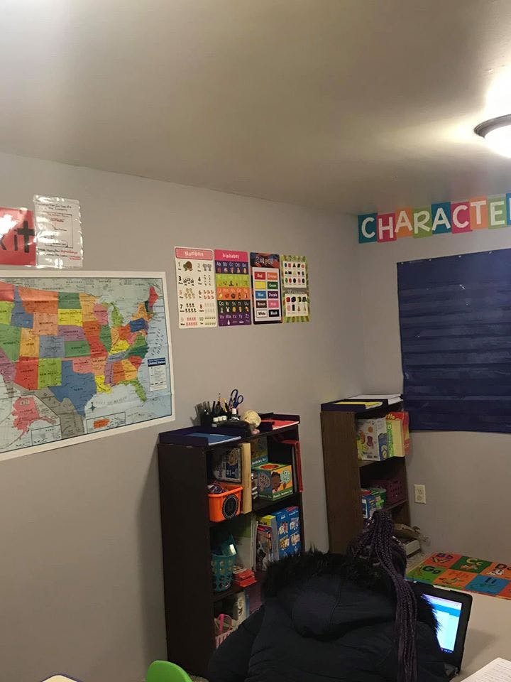 Classroom with a map, educational posters, and bookshelves