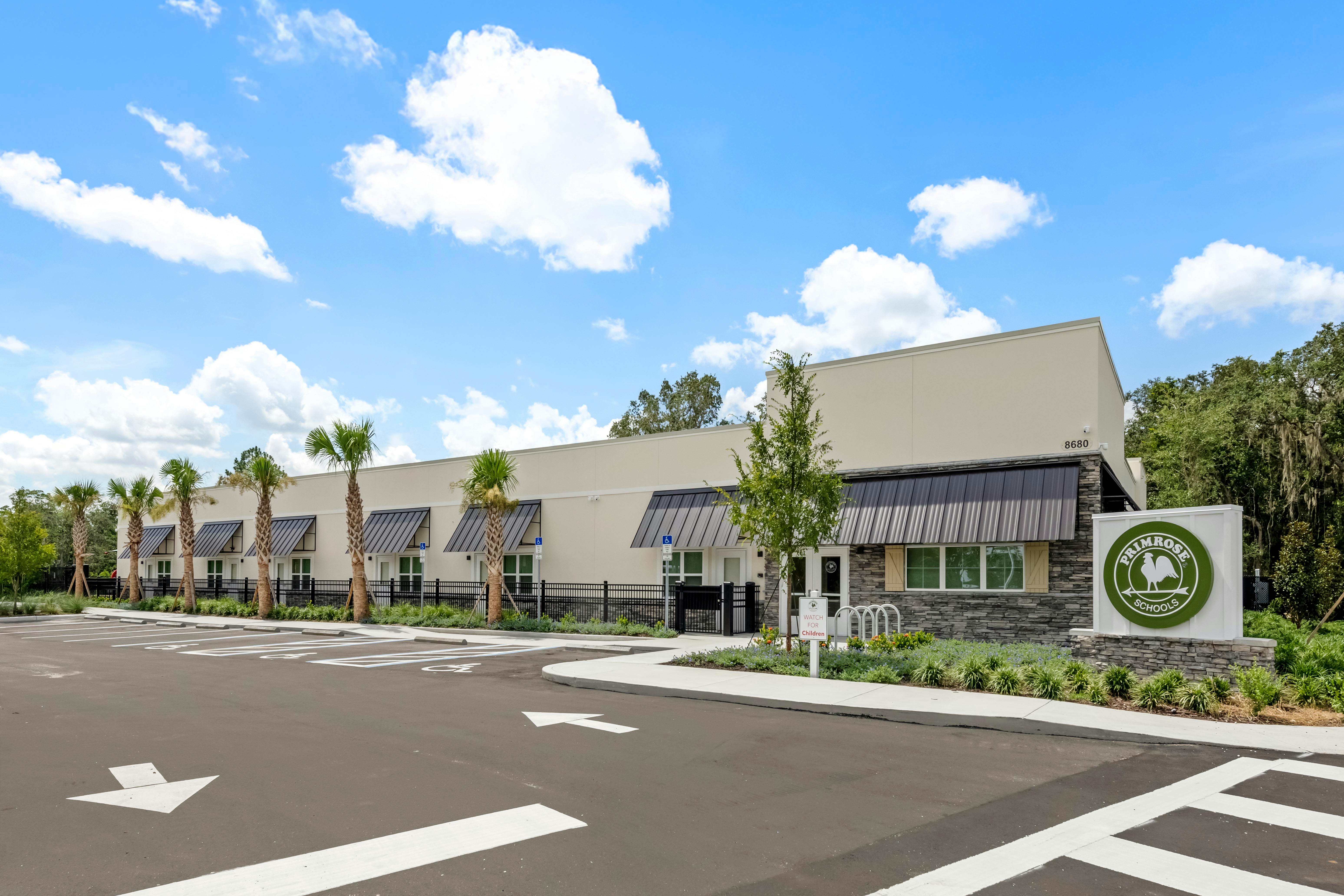 Exterior of Primrose Schools building with parking lot and signage