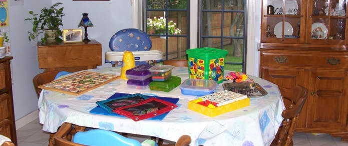 Table with a white tablecloth covered in various toys and games