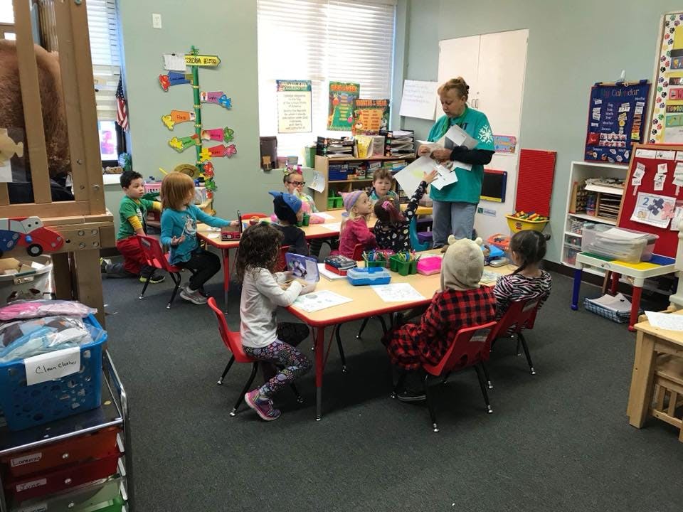 Adult and children in a classroom
