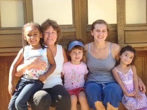 Two adults and three children sitting together