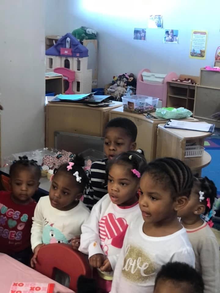 Group of children standing in a classroom