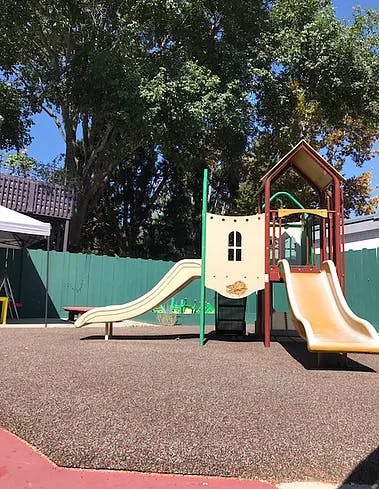 Playground with two slides and a climbing structure
