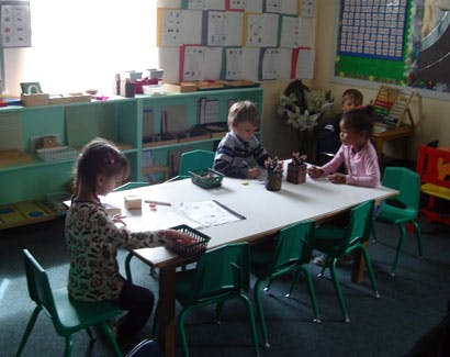 Children sitting at a table in a classroom