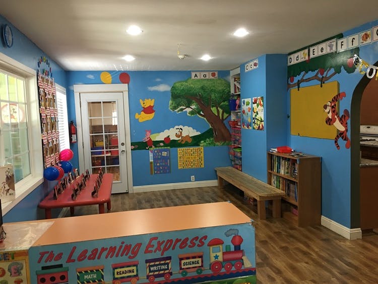 Classroom with blue walls, murals, and a counter with "The Learning Express" text