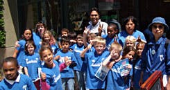 Group of children and adults in blue shirts