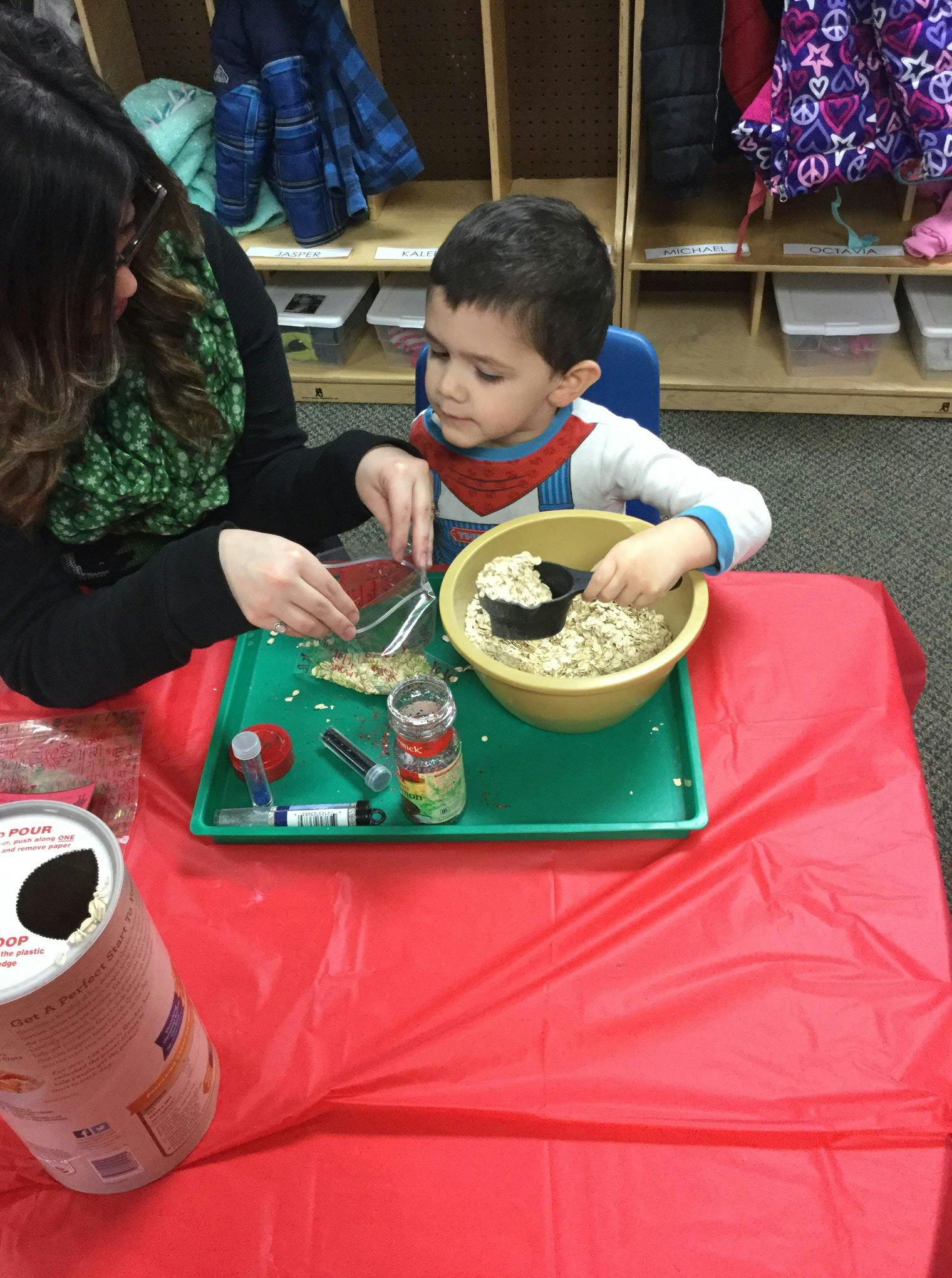 Adult and child scooping material from a bowl