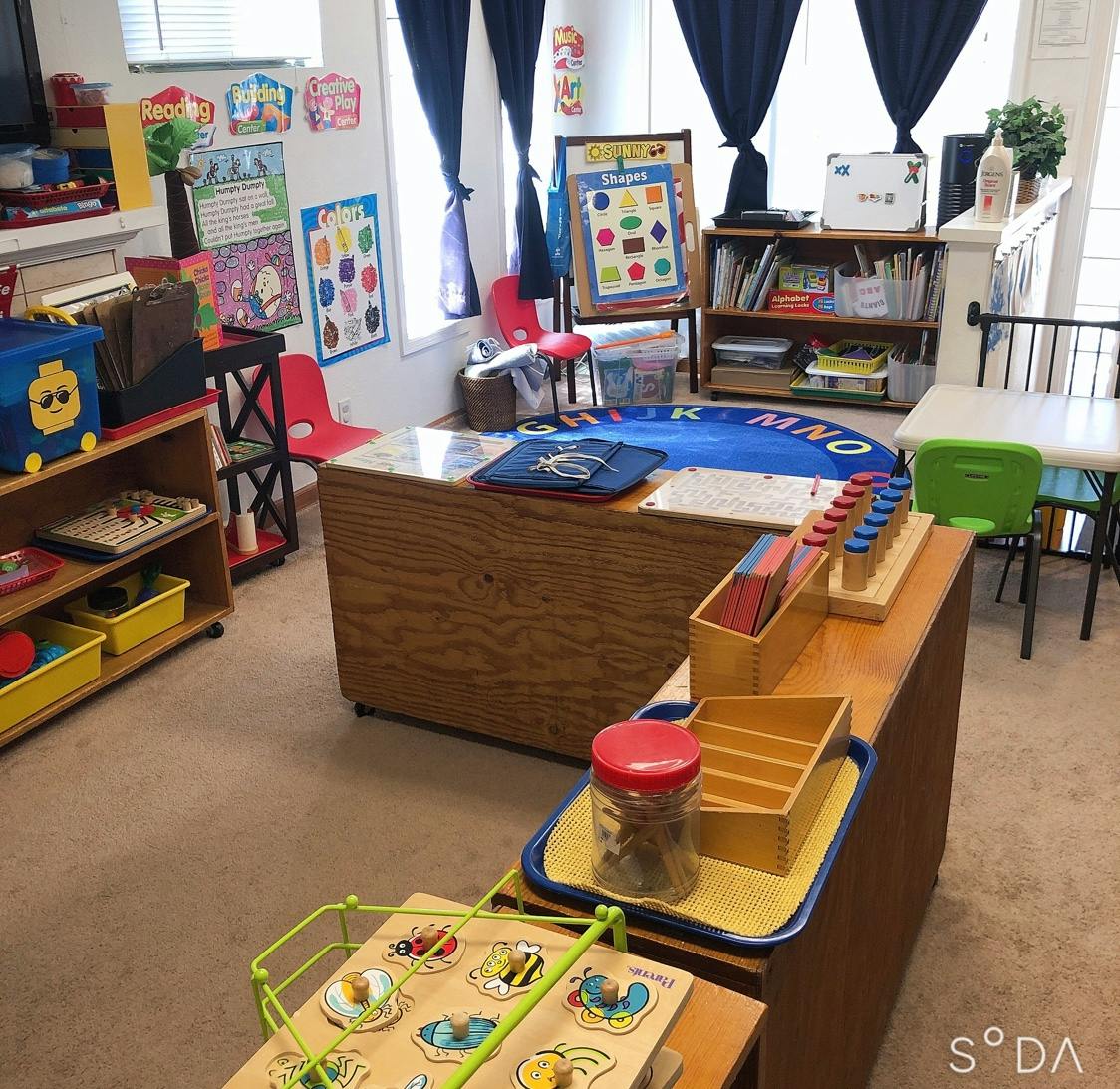 Classroom with learning materials, small tables, and chairs