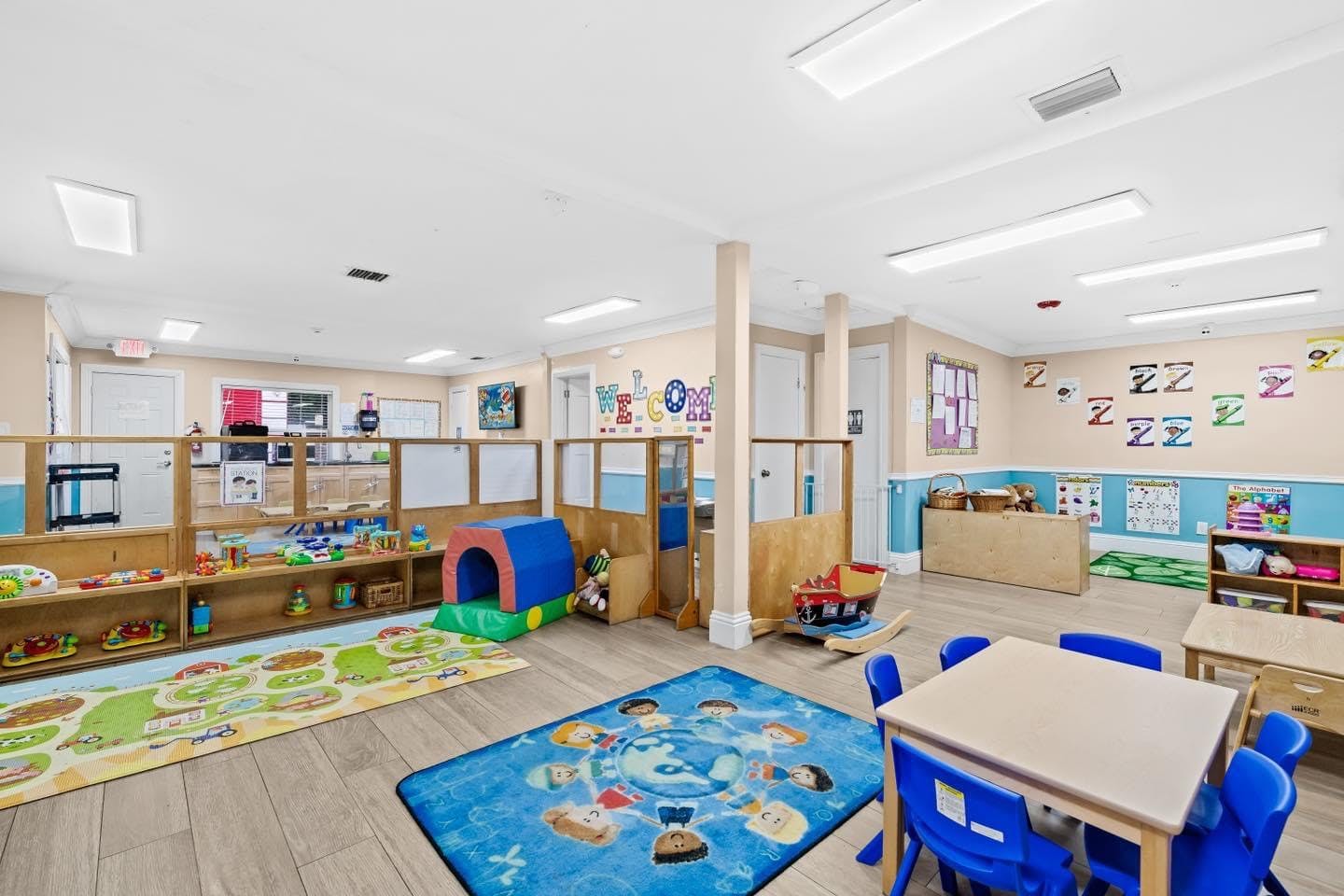 Playroom with tables, chairs, and play areas