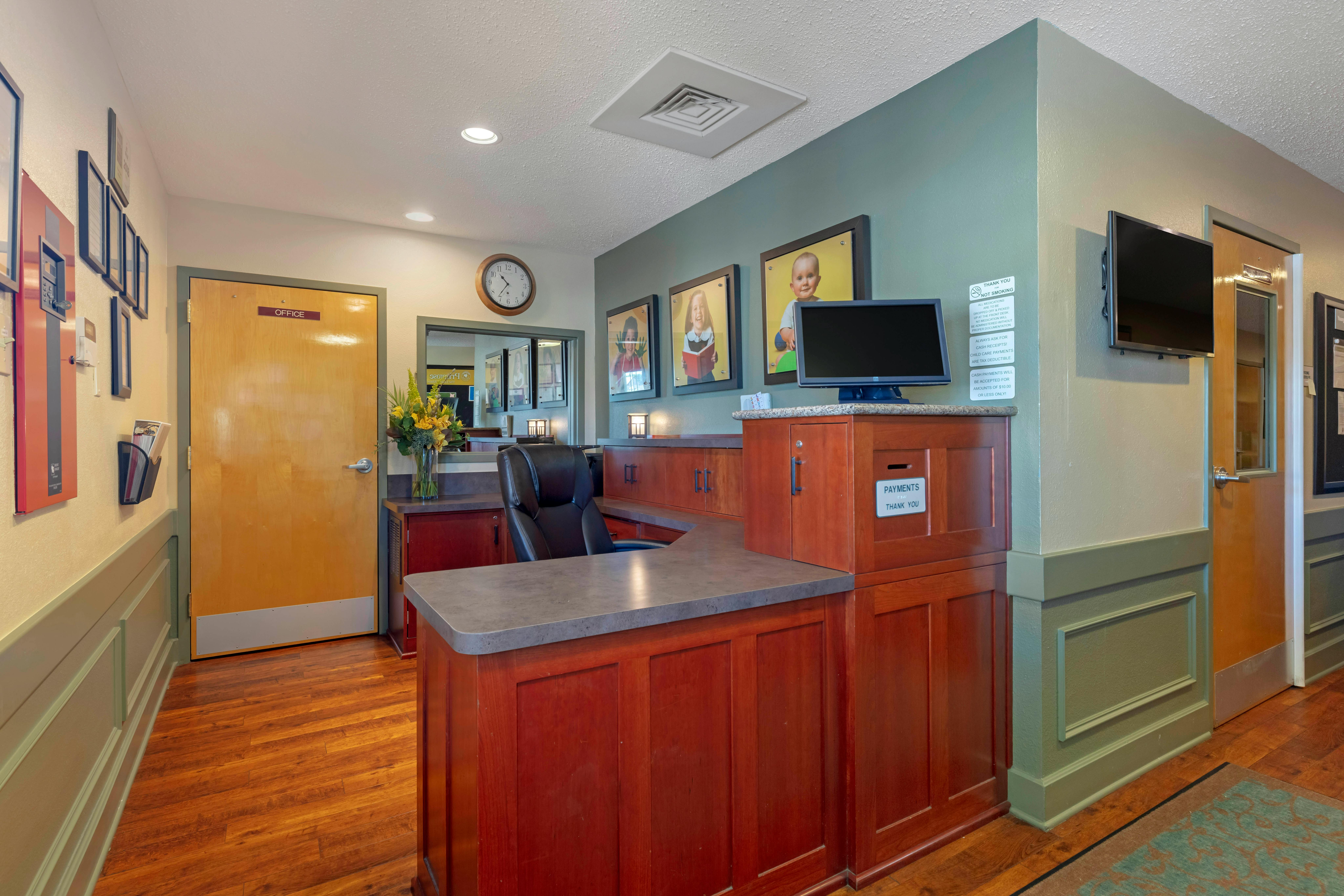 An empty reception desk with an office door to the left