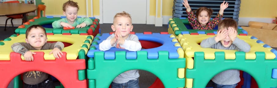 Children playing in colorful block structures