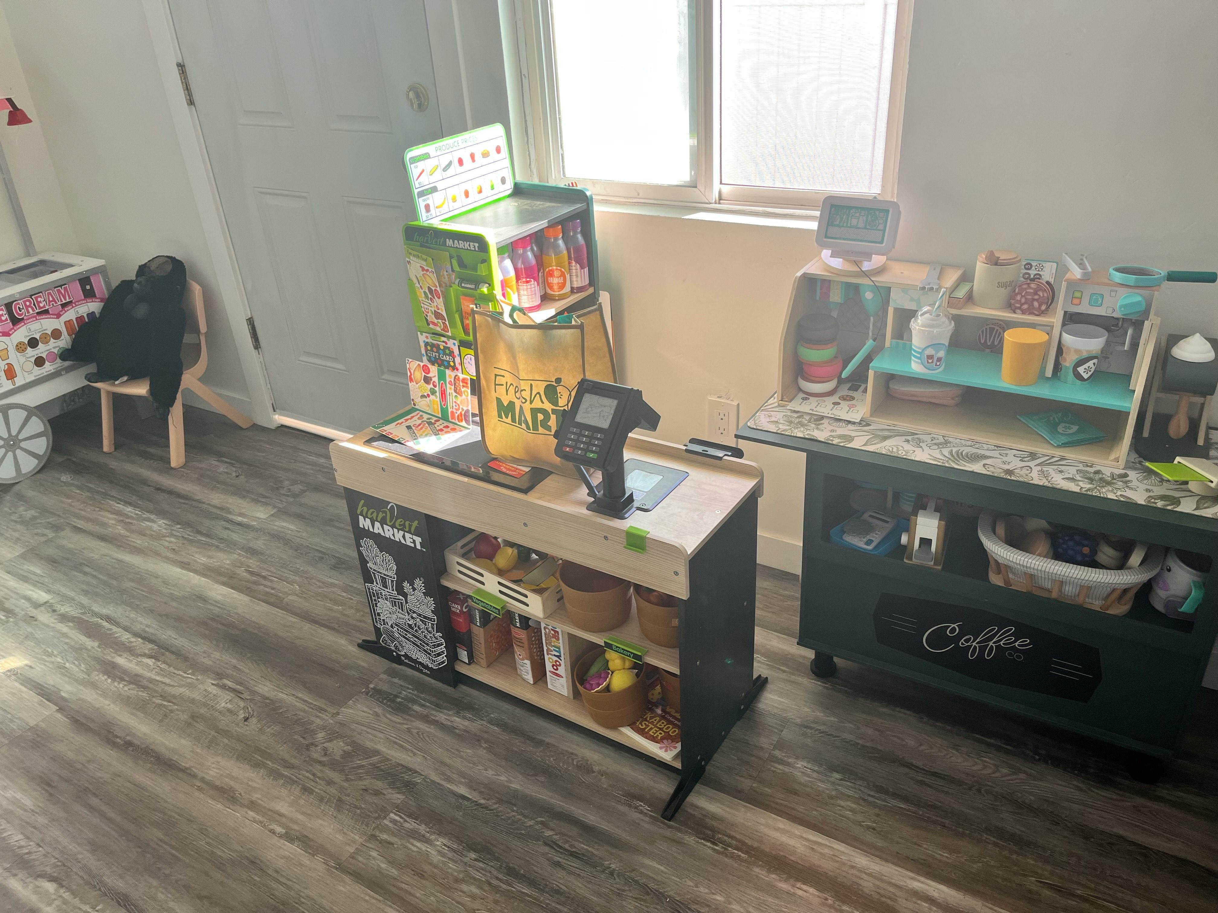 Play kitchen and market stand in a room