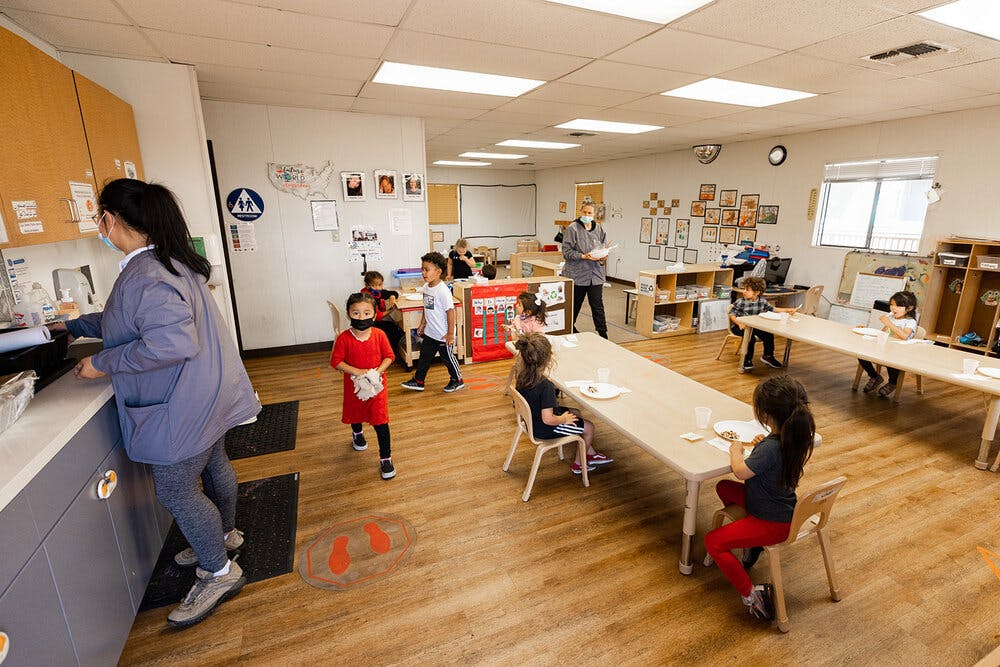 Adults and children in a classroom