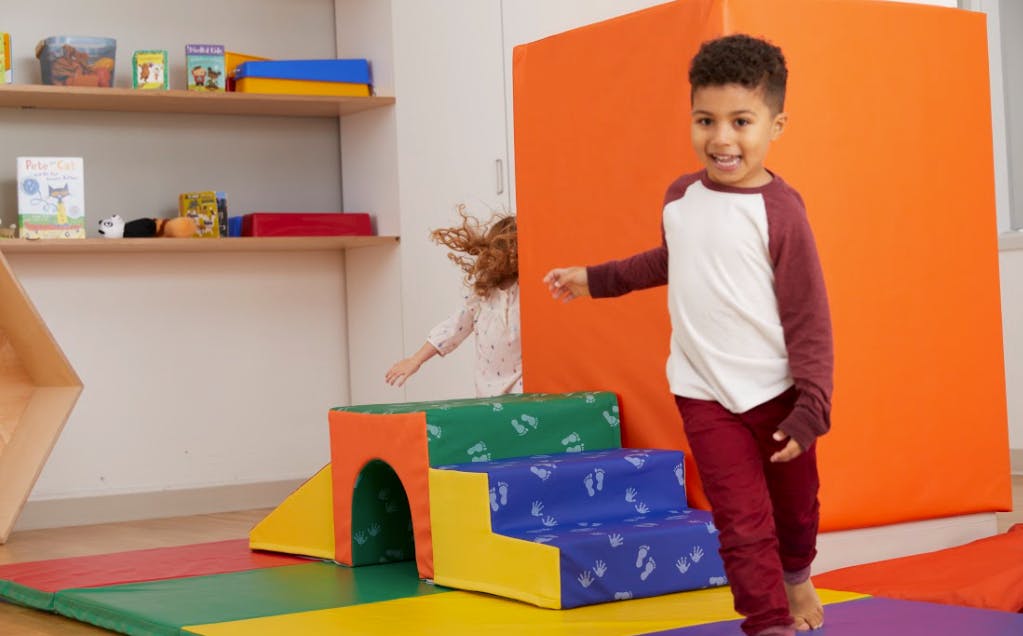 Child walking on soft play equipment