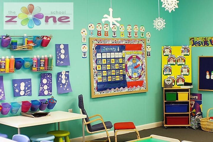 Classroom with a calendar on the wall and art supplies
