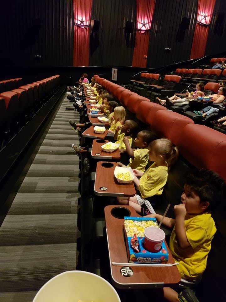 Children in a movie theater eating popcorn