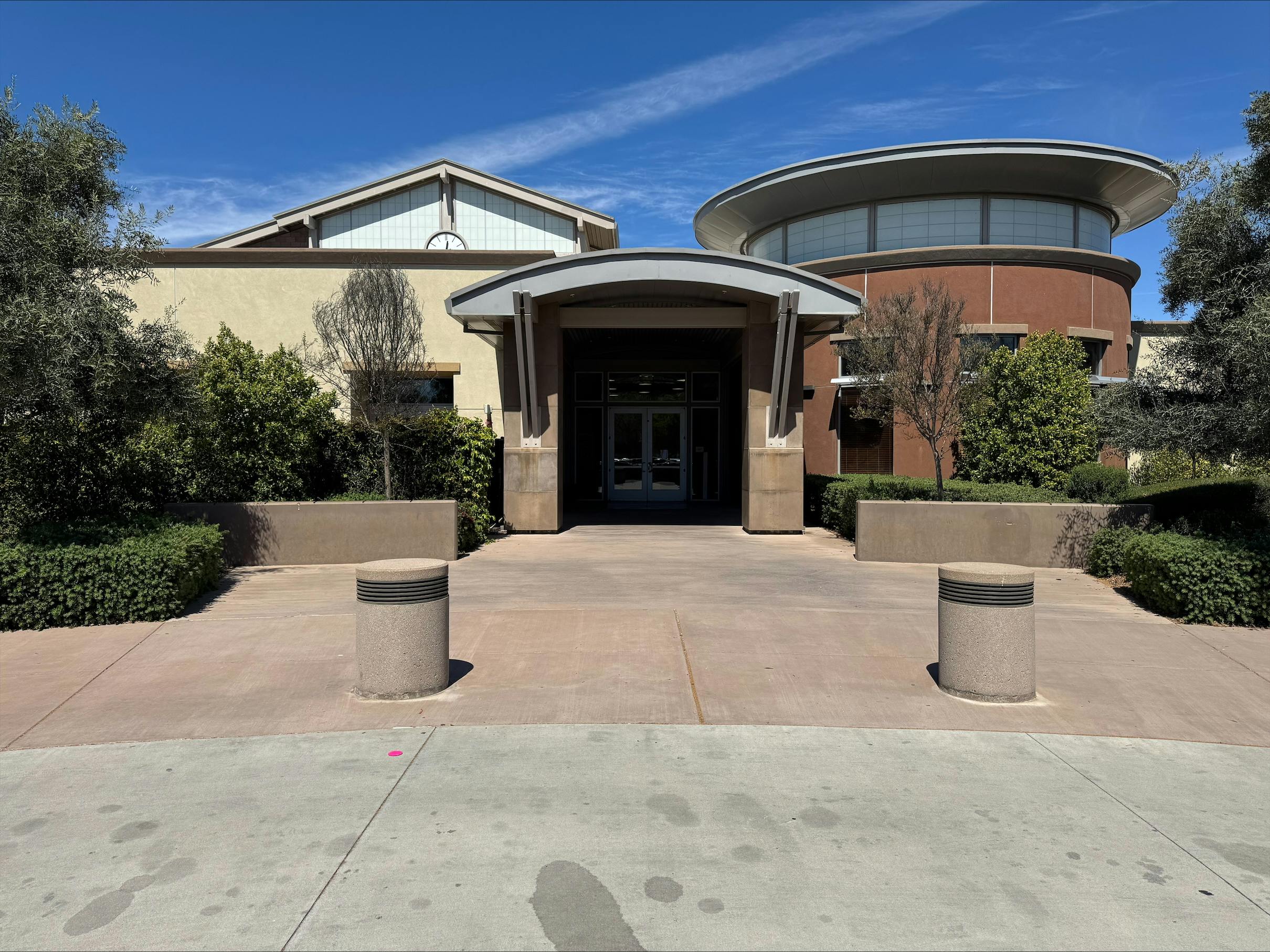 Building exterior with an arched entrance and a circular section