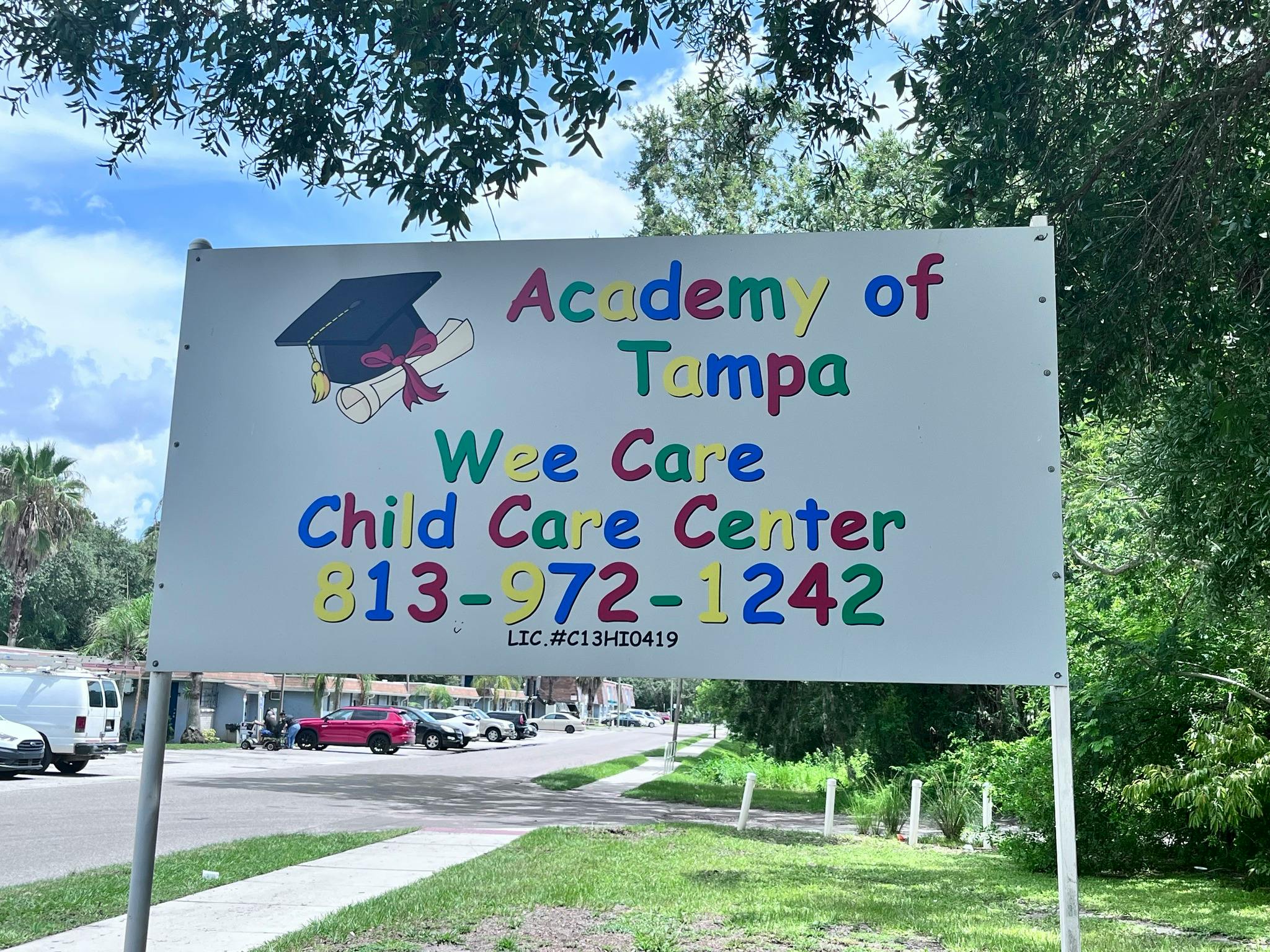Sign for Academy of Tampa Wee Care Child Care Center with phone number