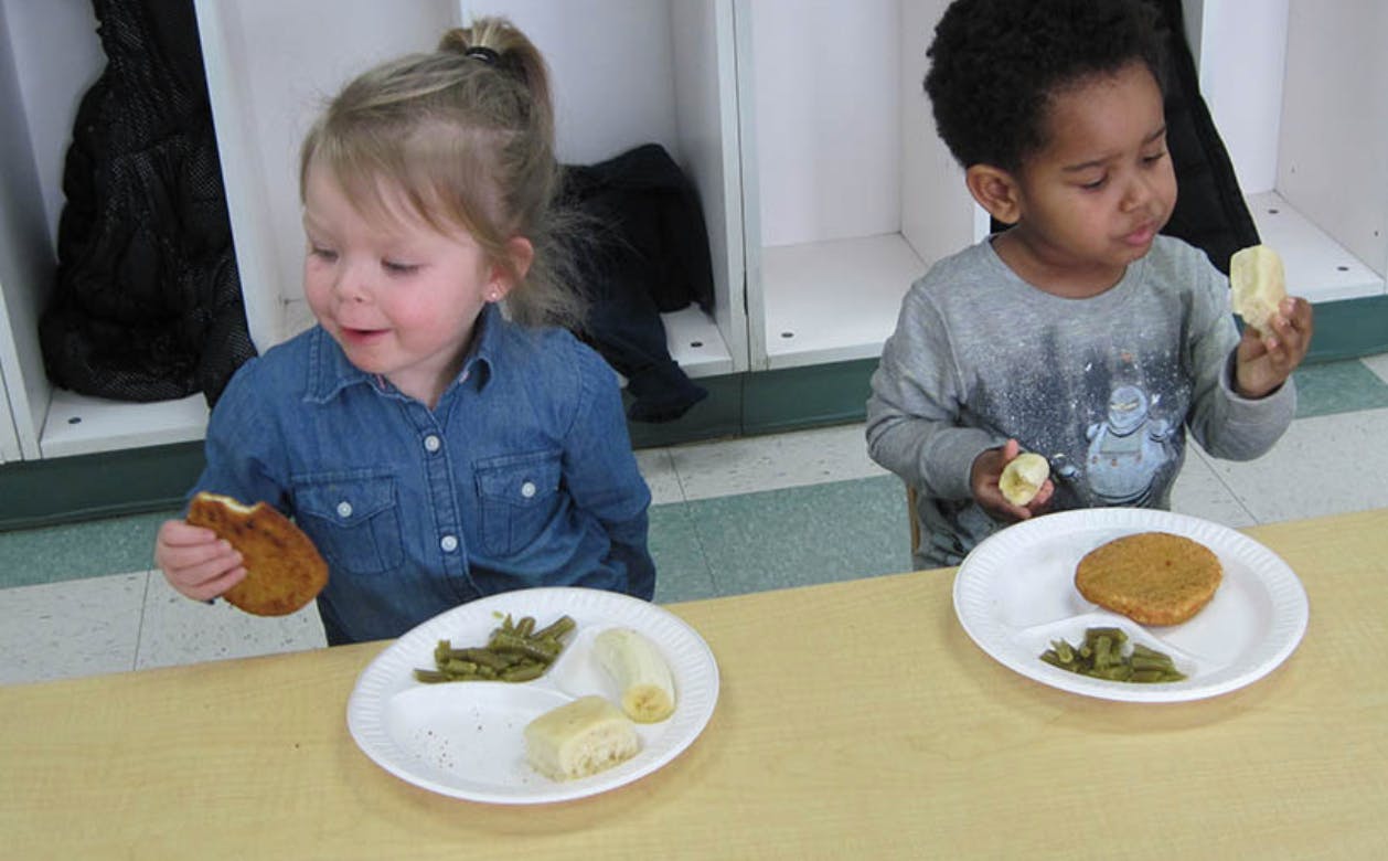 Two children eating at a table