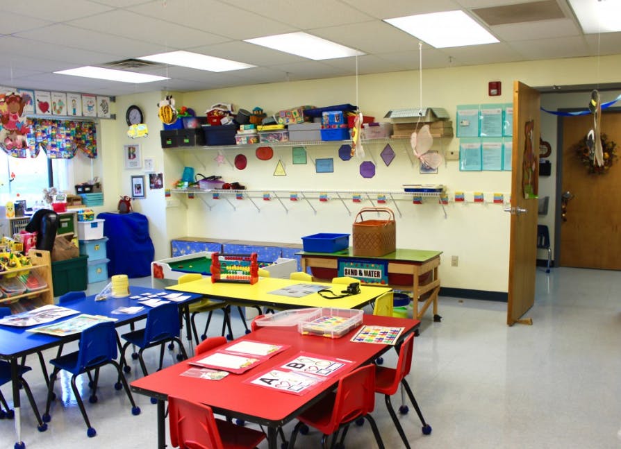 Empty classroom with small tables and chairs