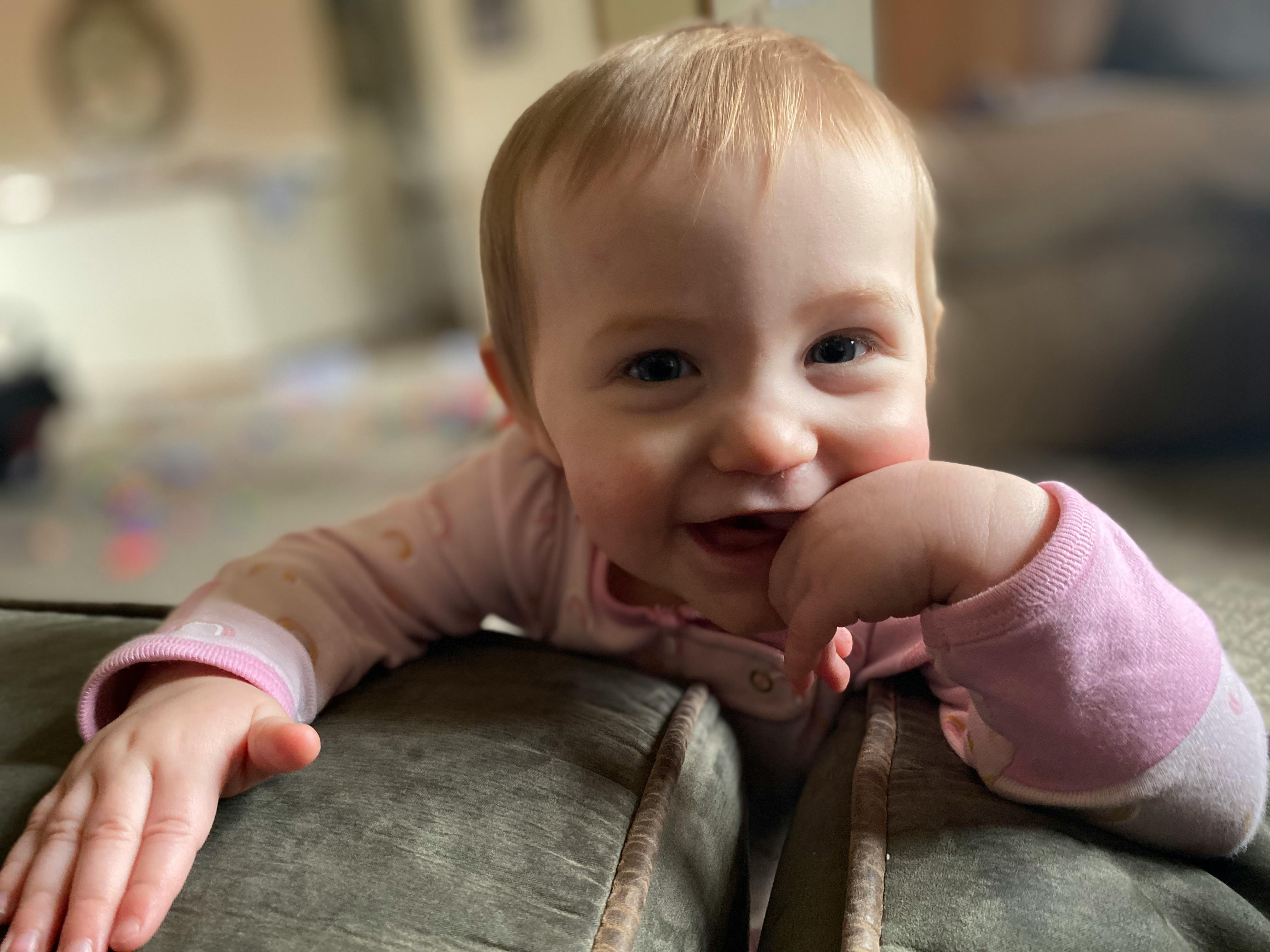 Child looking over a couch