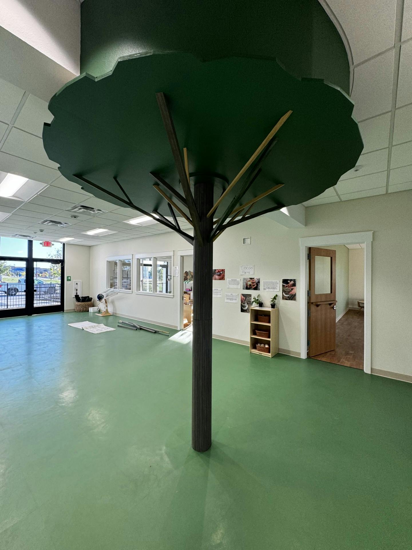 Indoor room with a large decorative tree in the center