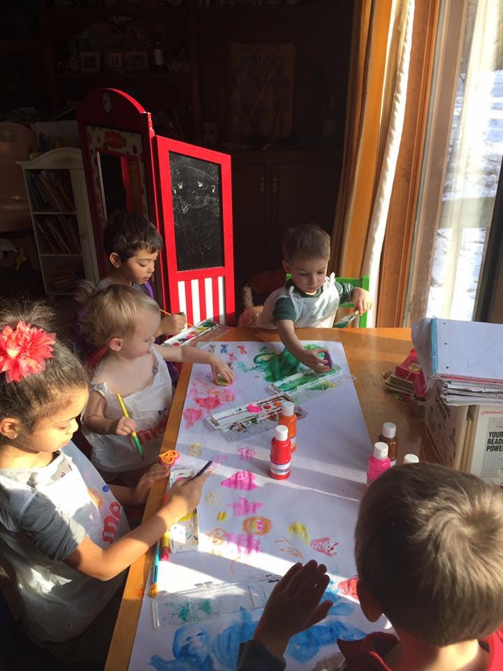 Children painting at a table