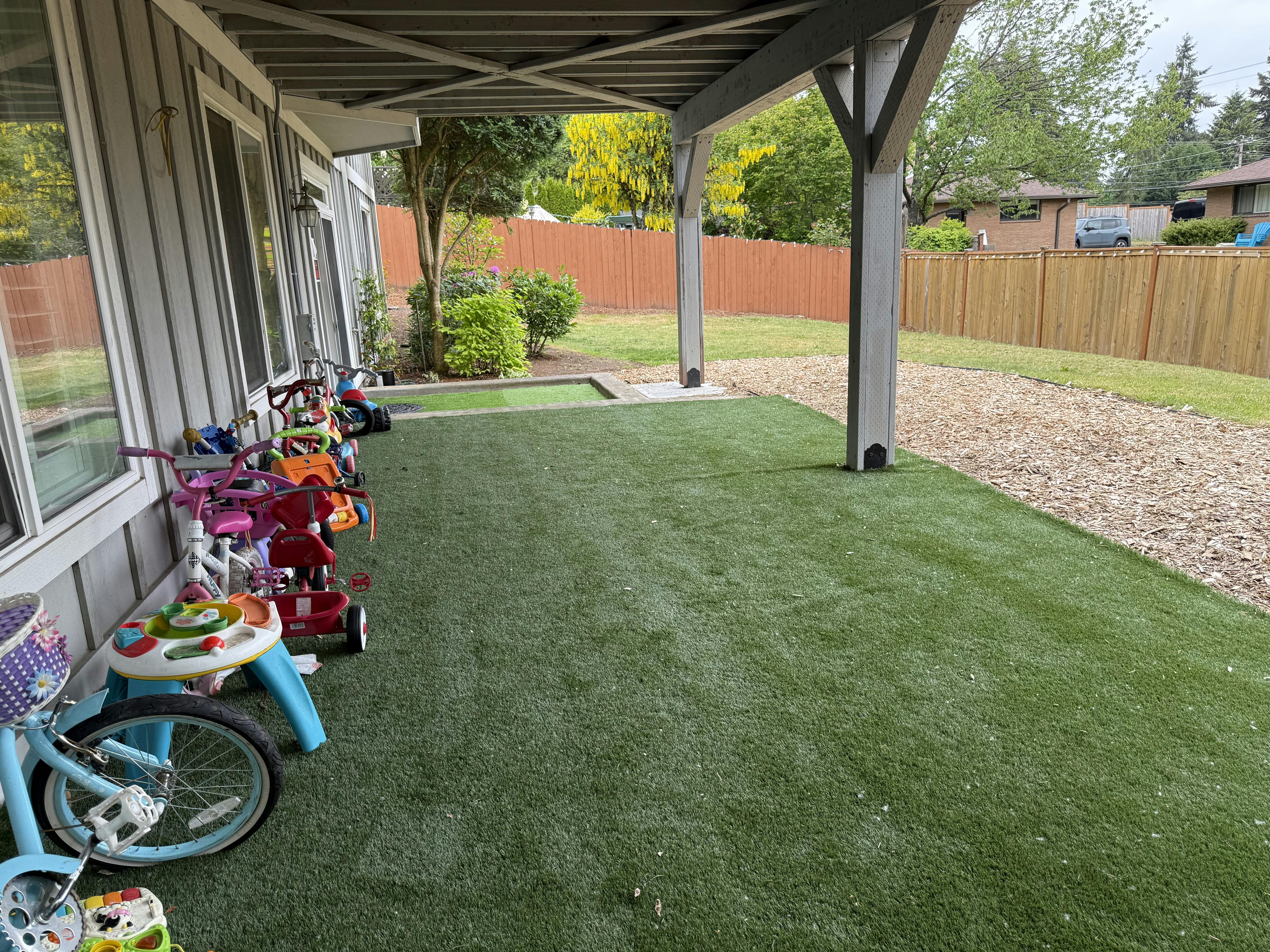 Collection of children's bikes and ride-on toys on a patio