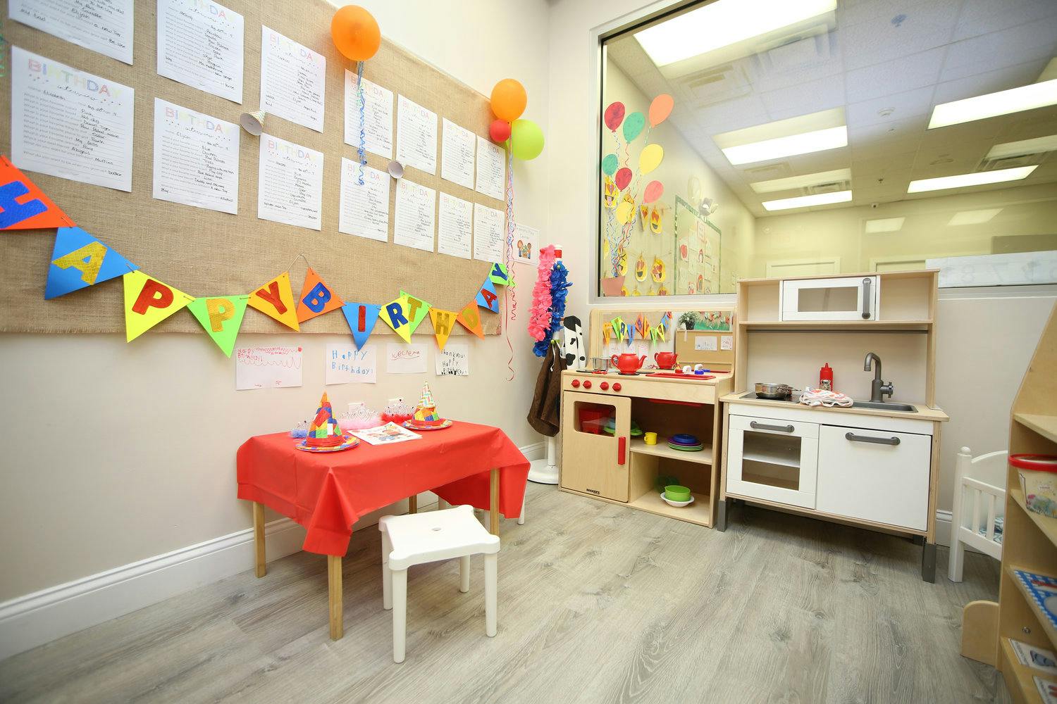 Playroom with a small table and chairs, and a toy kitchen set