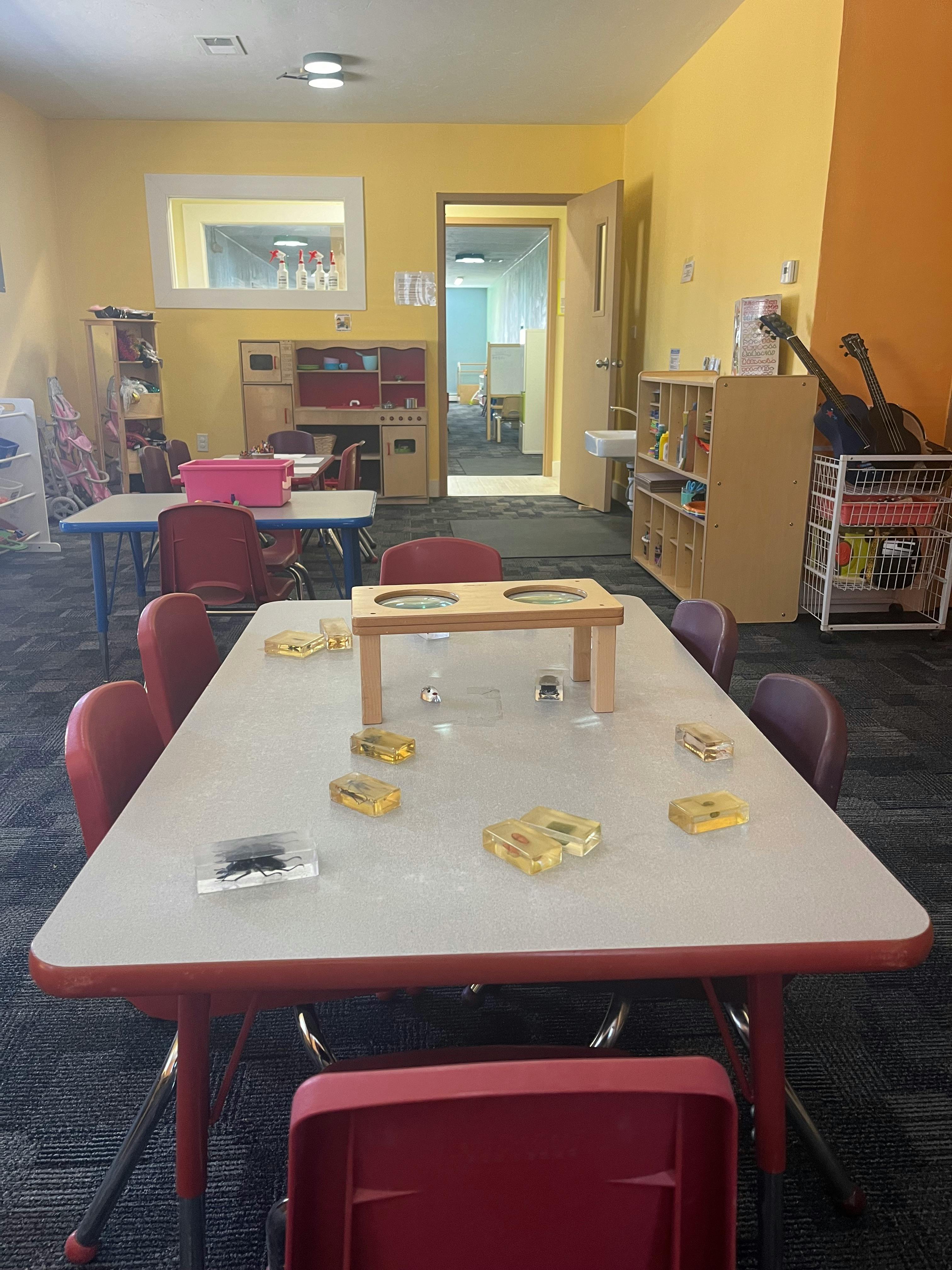 Classroom with tables and chairs, toys on a table
