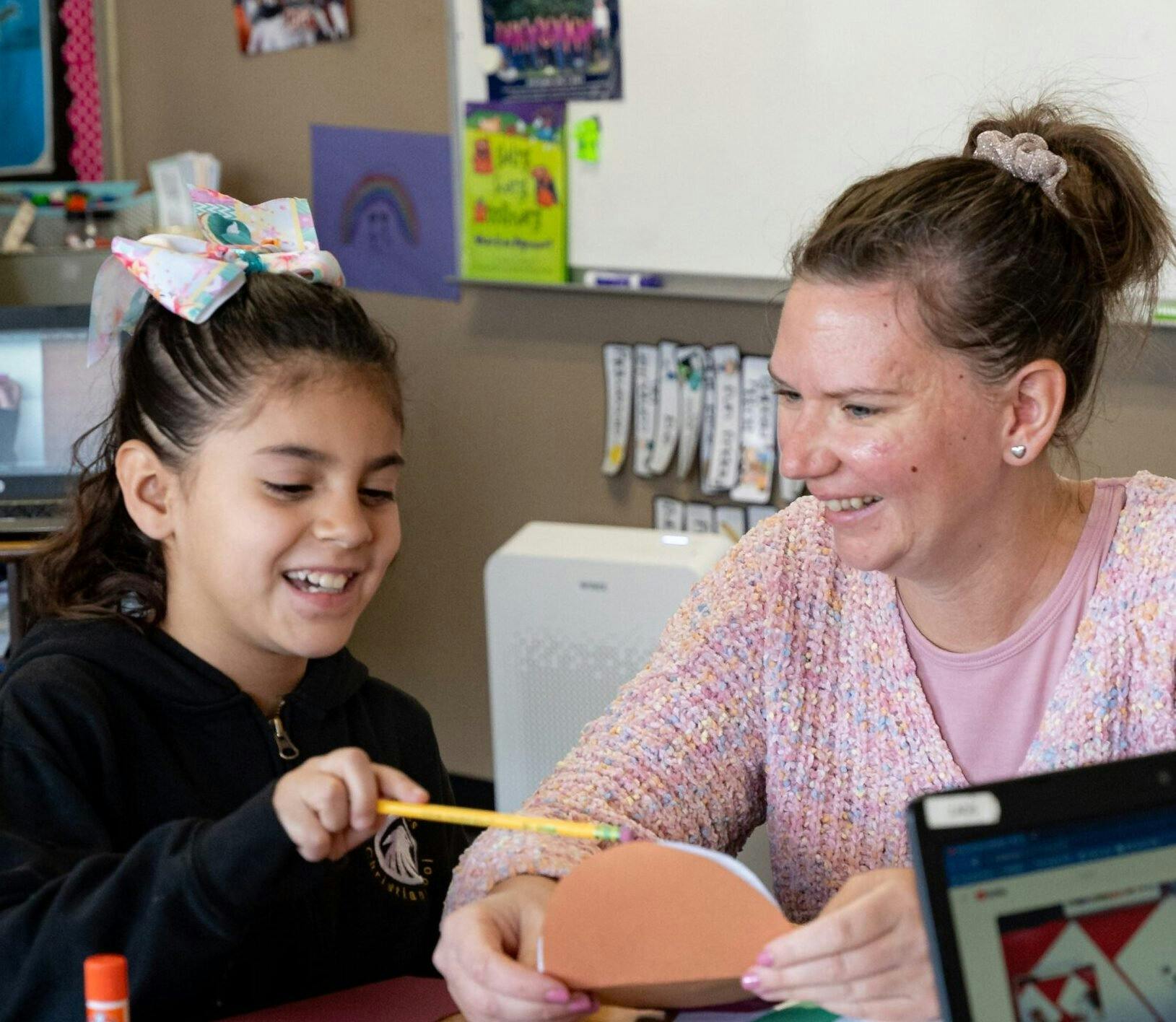 Adult and child making crafts in a classroom