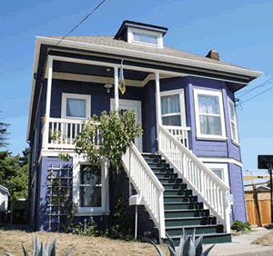 Two-story house with a porch and white staircase