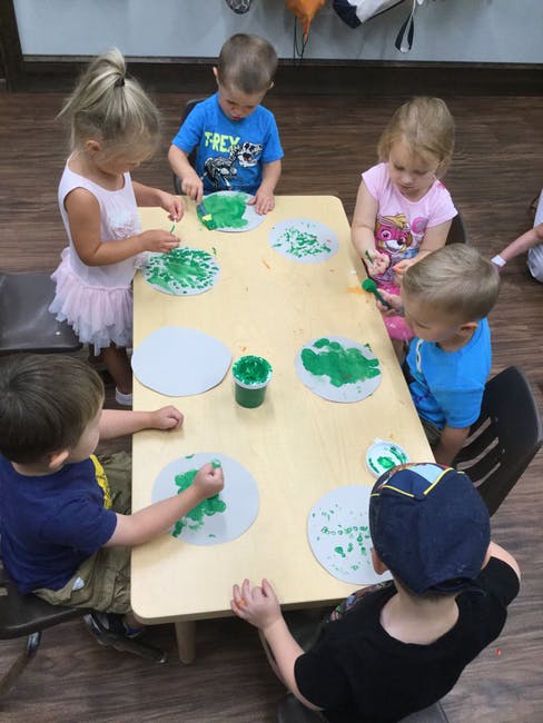 Children painting at a table