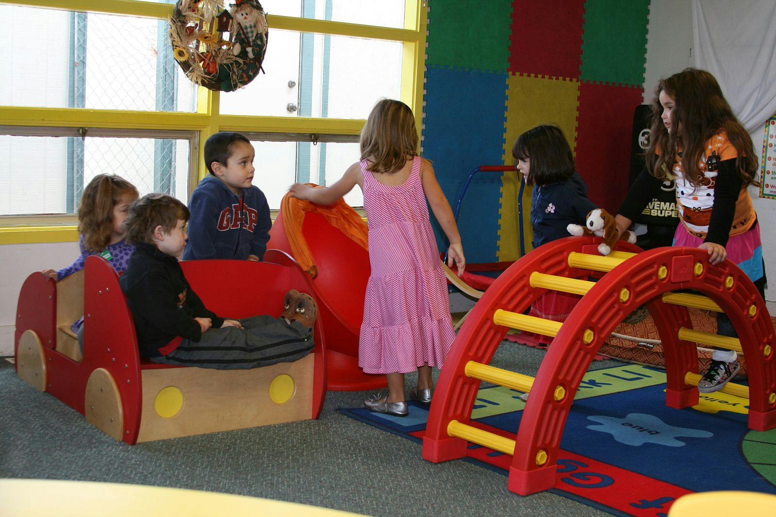 Children playing on indoor playground equipment