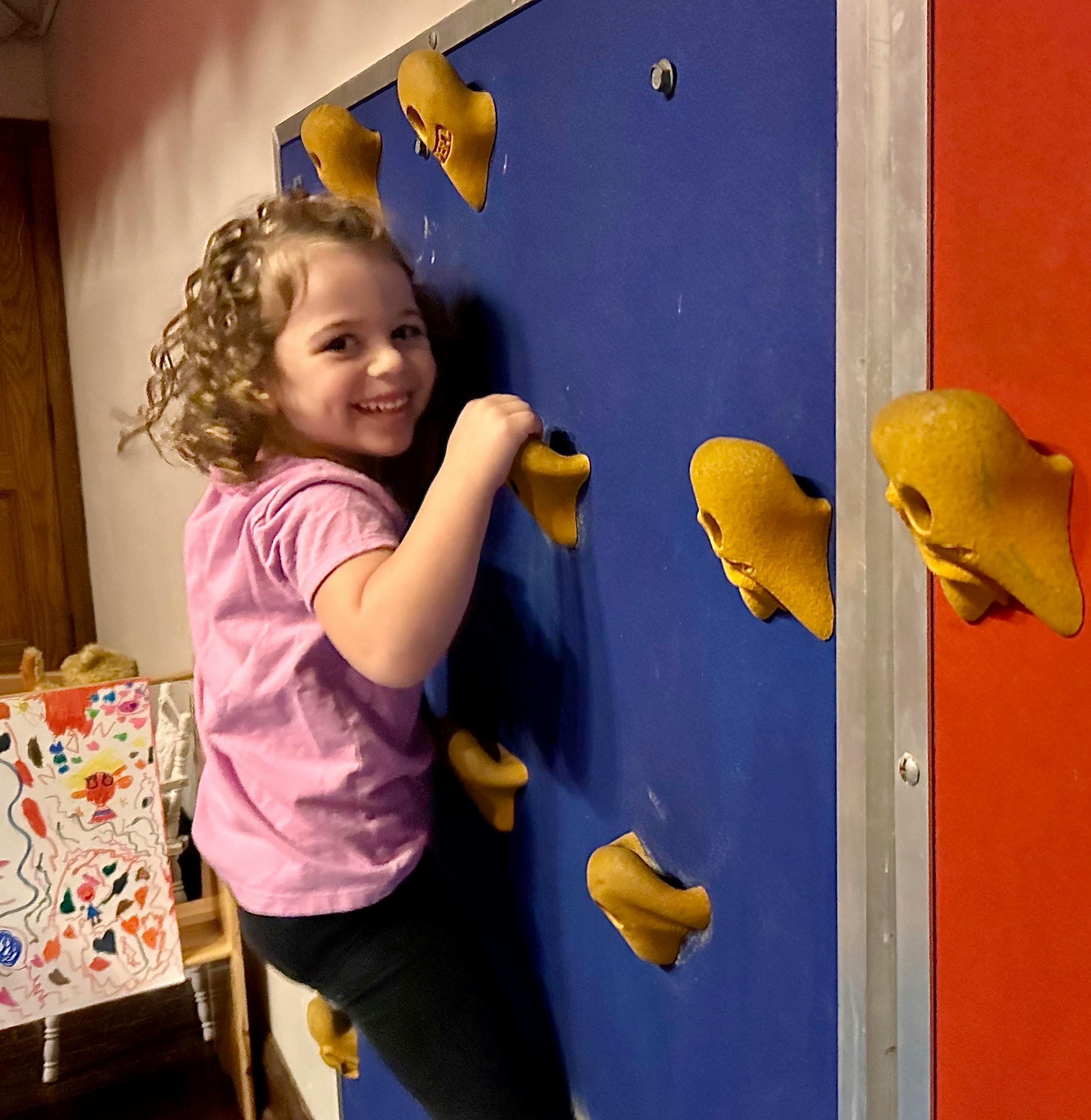 Child climbing on a rock wall