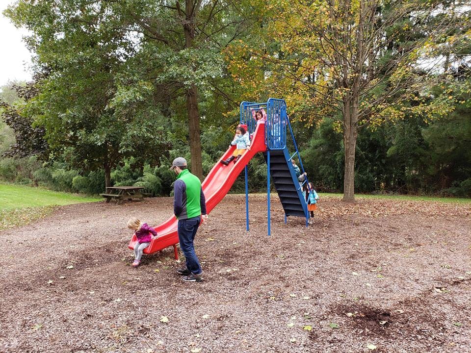 Person and children on a playground slide