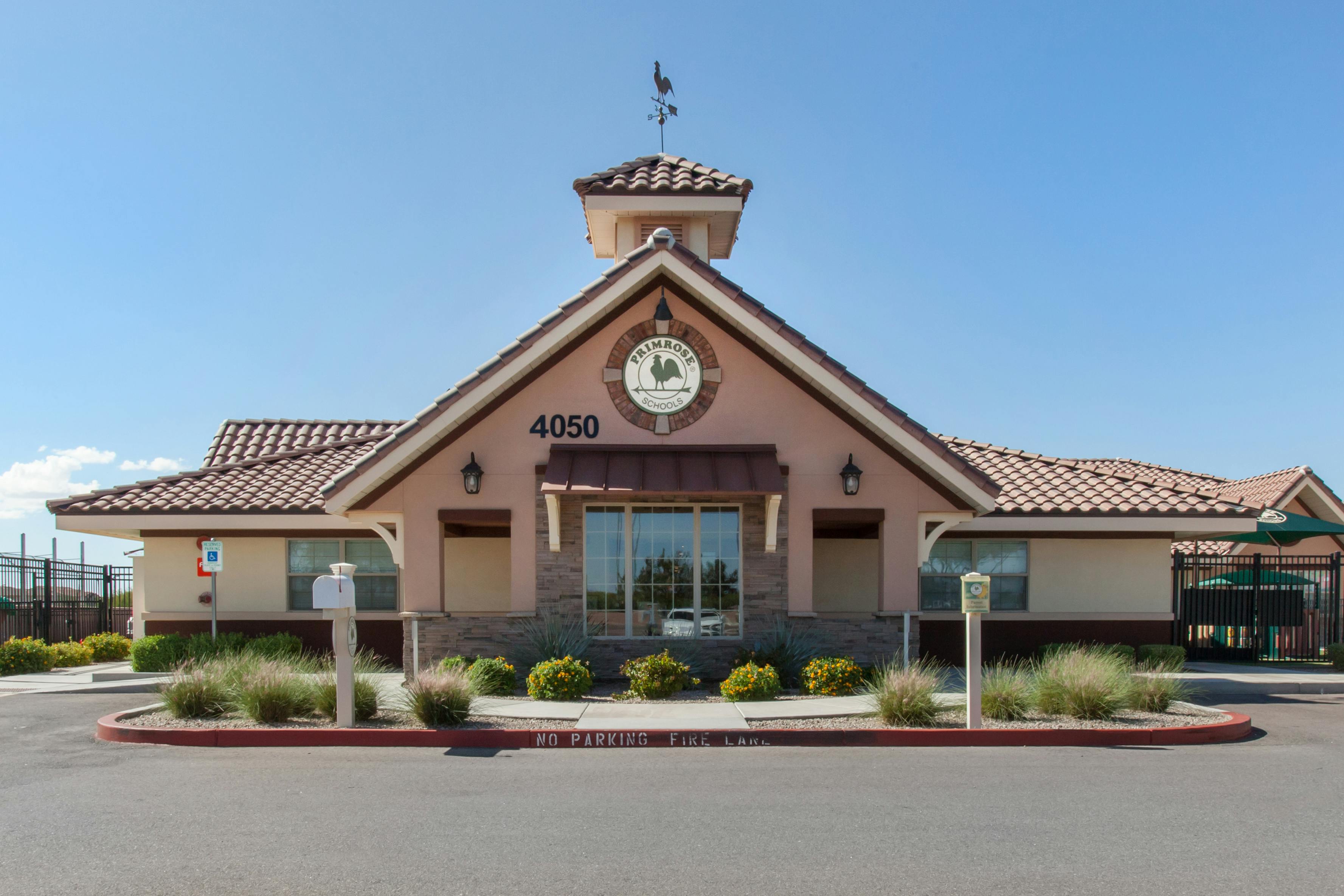 Primrose Schools building with a rooster weather vane and address 4050