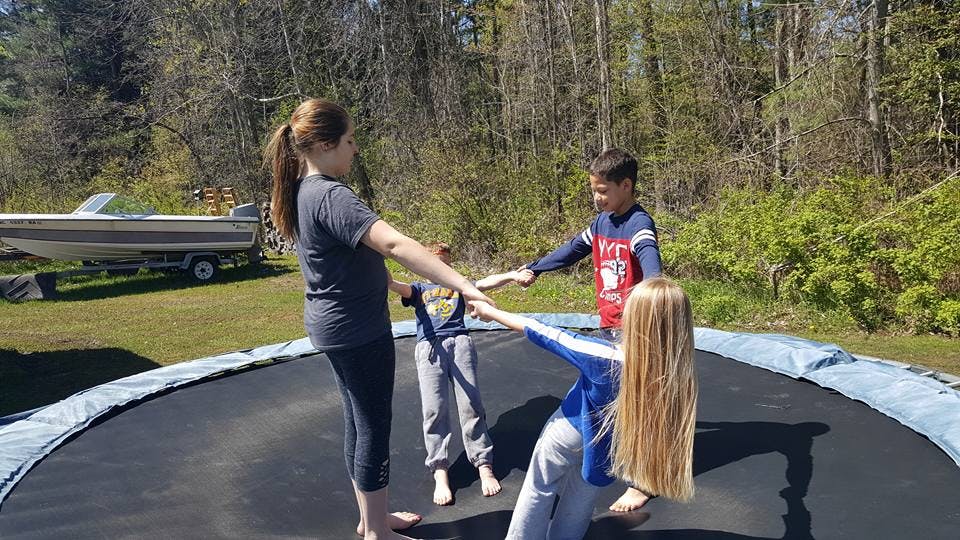 People holding hands on a trampoline