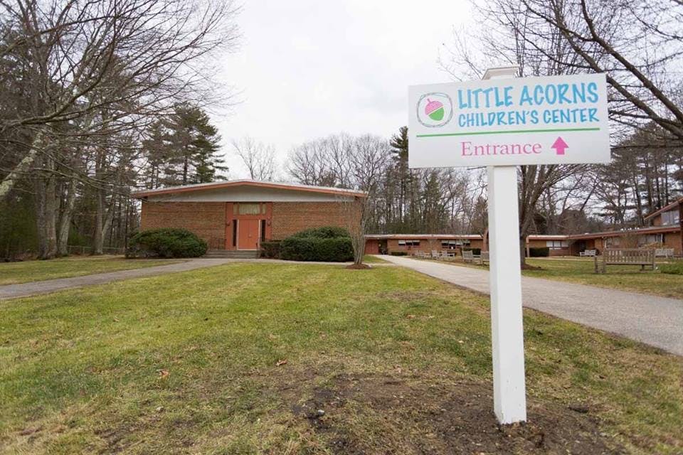 Little Acorns Children's Center sign with building in background