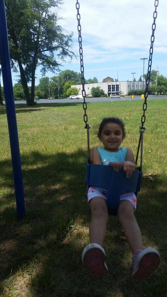 Child in a swing at a playground