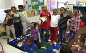 Group of children standing in a classroom
