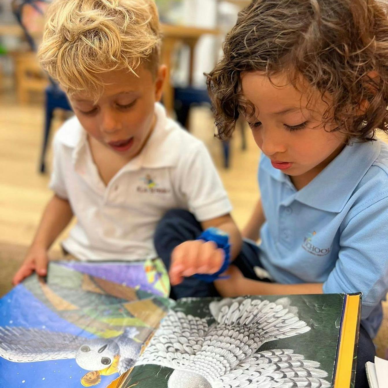 Two children looking at an open book
