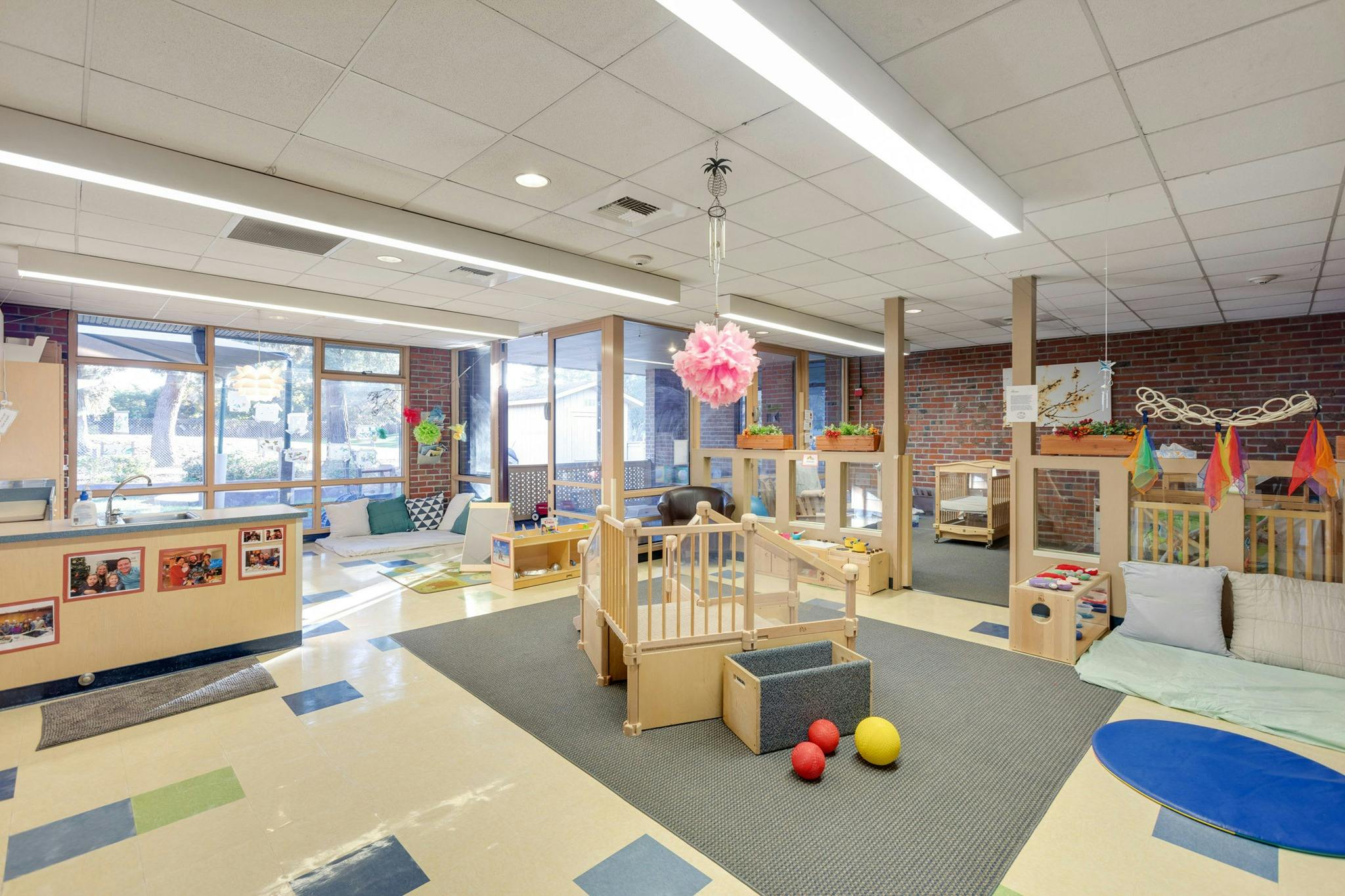 Empty classroom with play areas and large windows