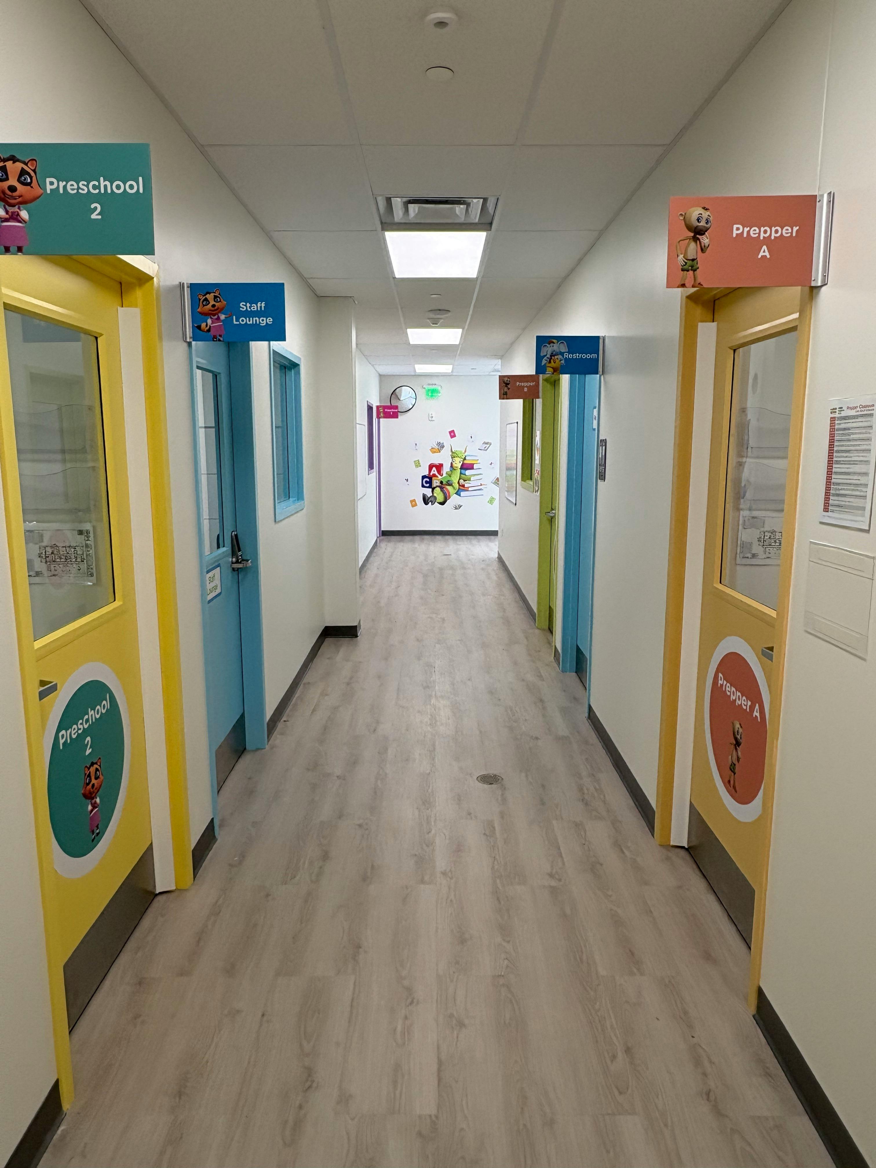 Hallway with multiple doors, some labeled "Preschool" and "Prepper"