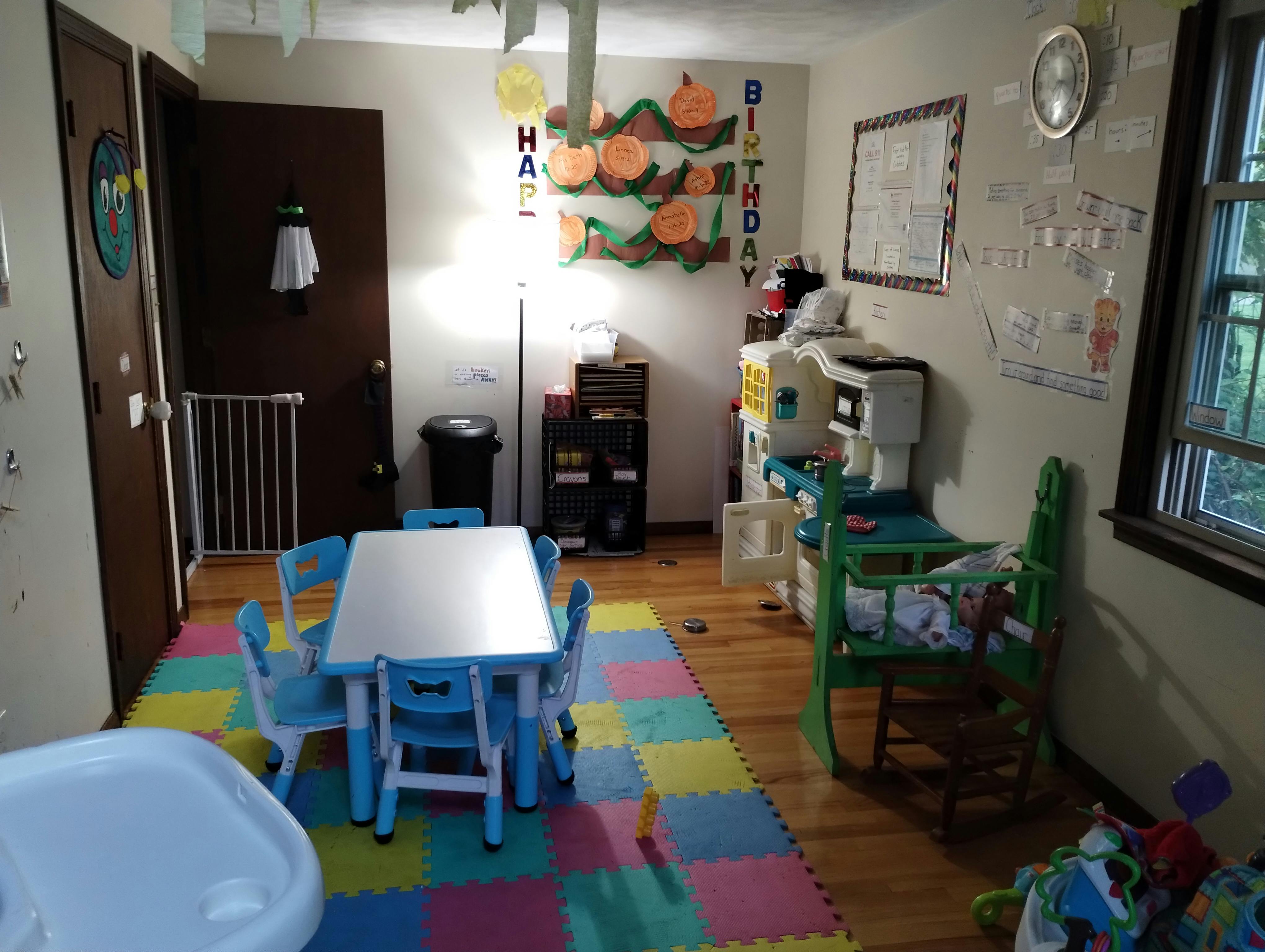 Child's play area with small table and chairs on a colorful mat
